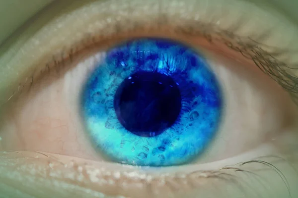 Big blue eye, pupil large, clouds inside.