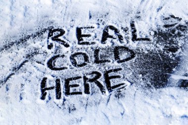 Real cold here inscription on ice. clipart