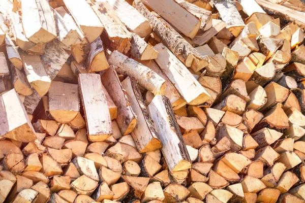 Dry chopped firewood logs in a pile.