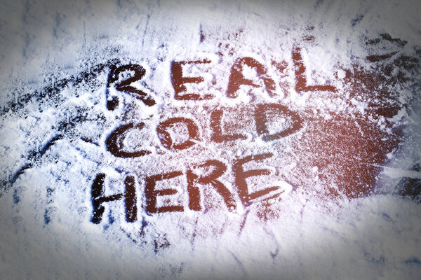 Real cold here inscription on ice, toned.