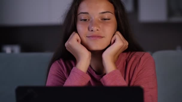 Pretty brunette in purple sweatshirt puts head on hands — Stock Video