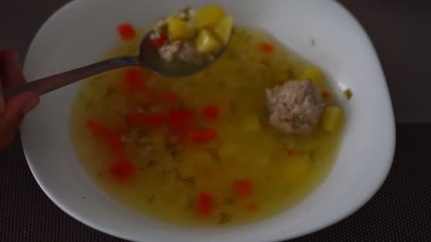 Woman eats delicious soup with meatballs upper view — Stock Footage Woman eats delicious soup with meatballs upper view Video Clip
