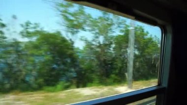 ülke ve deniz manzaraları tren penceresinin dışında değişir.