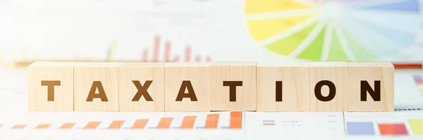 Szó adózási készült betűkkel fa kockák az asztalon — Stock Fotó