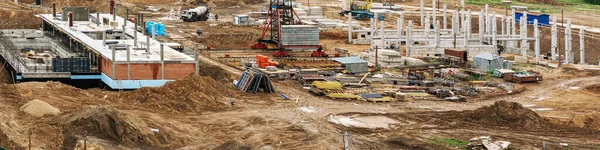 building construction site with machines and ground piles