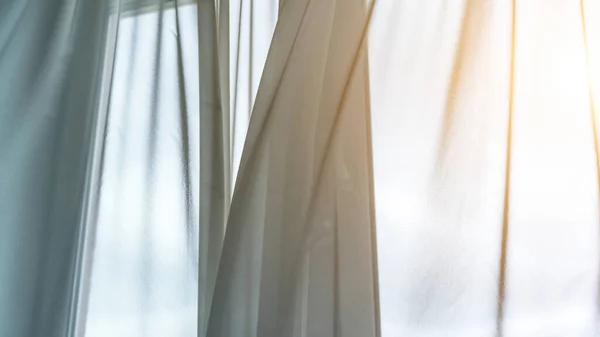 window transparent curtains waved by light wind closeup