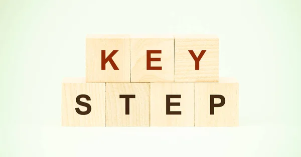 words key step made with black letters on wooden blocks