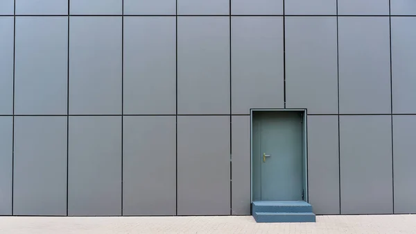 Gri merdivenli yerel ticari binanın küçük kapısı.