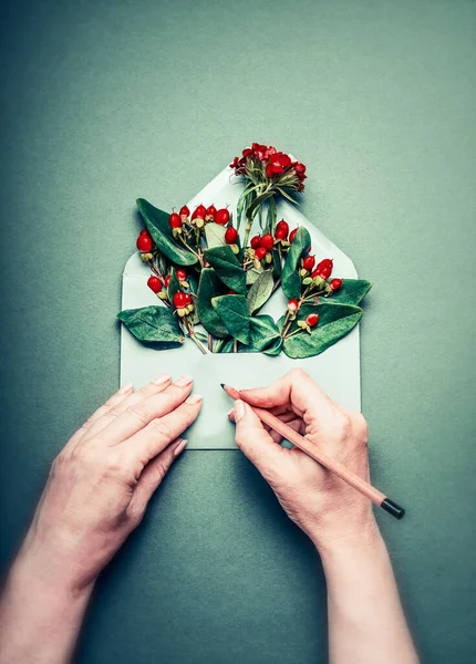 Weibliche Hände Schreiben Mit Bleistift Grußkarte Auf Geöffneten Umschlag Mit — Stockfoto