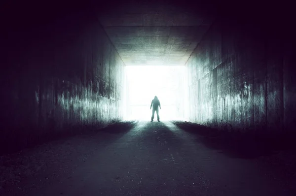 Silhouette Hooded Figure Looking Out Dark Tunnel Light — Stock Photo, Image