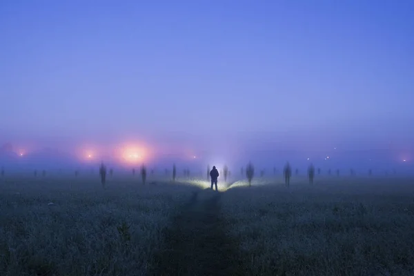 Lone Figure Torch Standing Field Ghostly Blurred Figures Appear Spooky — Stock Photo, Image