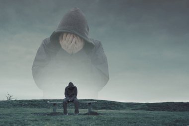 Bir çift pozlama kukuletalı bir figür kafası üzgün, yalnız ve depresyonda arıyorsunuz bir park bankta oturan yalnız bir kukuletalı figür üzerinde onun elinde. İle soğuk, mavi Düzenle.