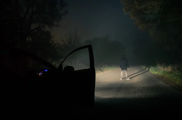 Lone Hooded Figure Standing Empty Misty Spooky Road Night Highlighted — Stock Photo, Image