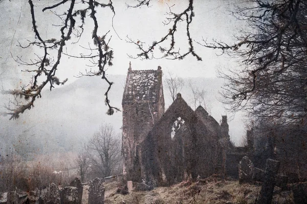 A spooky, abandoned graveyard with a ruined church in the background. With a vintage, grunge edit.