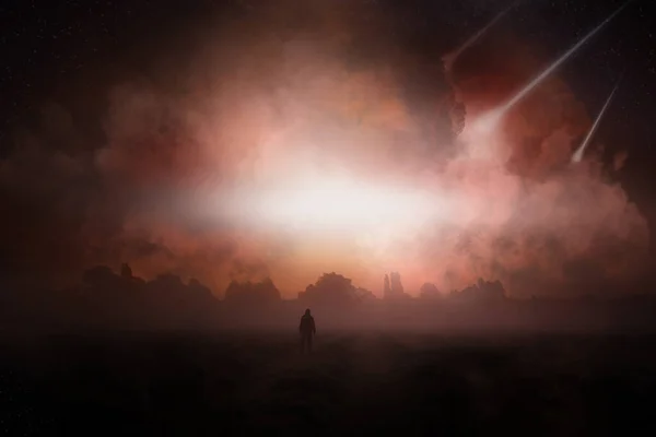 A post apocalypse scene showing a man standing, looking at asteroid falling from the sky.