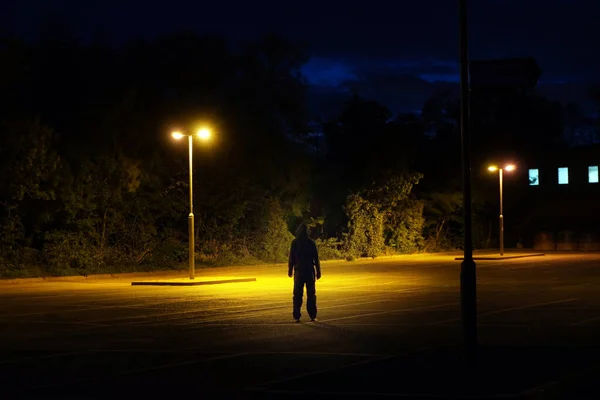 Hooded Figure Standing Street Lights Car Park Summers Night — Stock Photo, Image