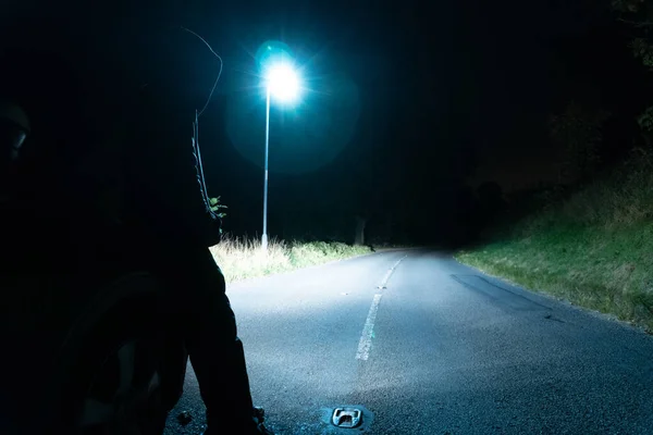 Moody Hooded Figure Standing Street Light Countryside Lit Car Headlights — Stock Photo, Image