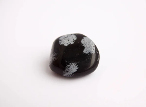 Macro shooting of natural mineral rock specimen - tumbled snowflake obsidian gemstone — Stock Photo, Image