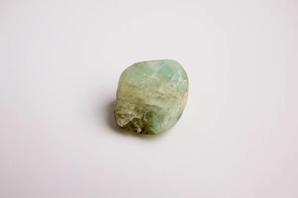 Natural mineral from geological collection - raw green Beryl crystal on white background. — Stock Photo, Image