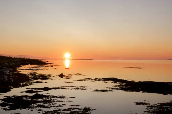 Beautiful early morning sunrise landscape of white sea water dramatic sunrise with first sunlight rays.