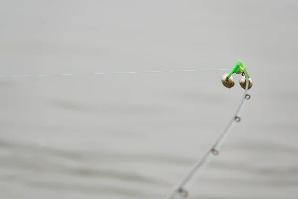 Fishing bell at the end of a fishing rod. Bells will ring when the fish is hooked.