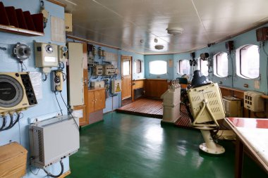 MURMANSK, RUSSIA jun 2019 Interior of the Soviet atomic icebreaker Lenin. The wheel running in the pilot house clipart