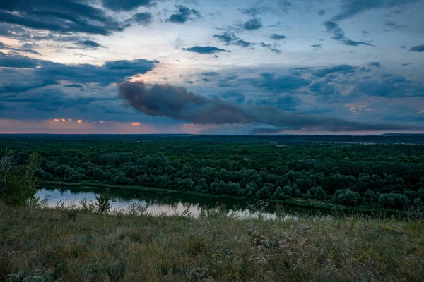 the Don river and a large forest fire with a lot of smoke in the forests of the Voronezh region in Russia. Fire extinguishing phase.