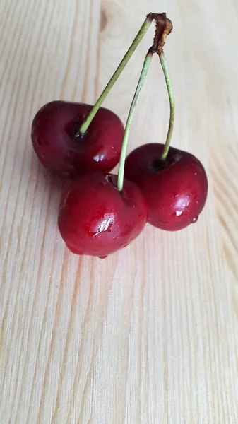 Cherries. Fresh sweet cherry on a woody background. Photo ripe cherries