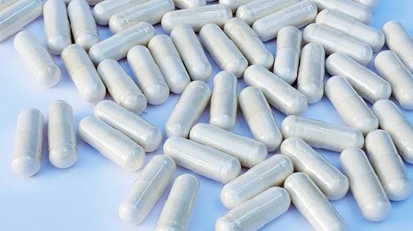 Capsules. Medications. Nutritional supplements. Background of red white capsules