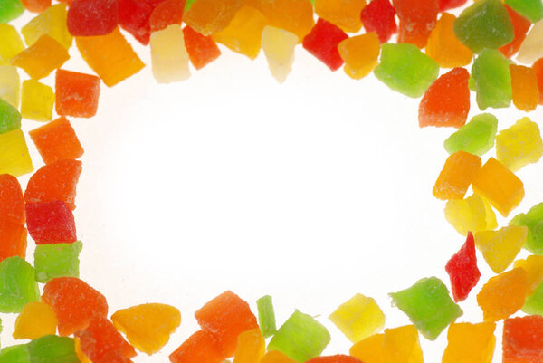 Candied fruit. Multicolored candied fruits. Frame of sweets. Candied fruits diced