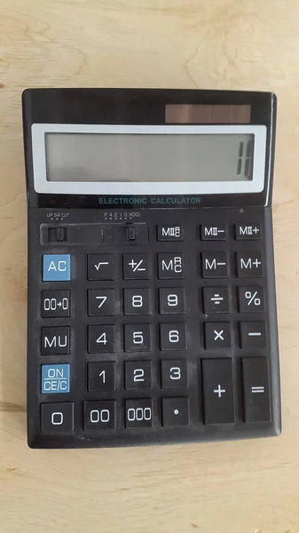 Calculator. Old calculator. Electronic calculator on wood background