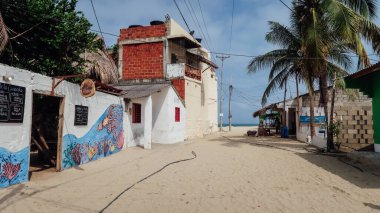 RINCON DEL MAR, COLOMBIA - CRCA FEBRUARY 2020: Güneşli bir günde Karayipler kıyısındaki küçük bir balıkçı kasabasında küçük bir balıkçı köyünde kum sokakları ve basit evler.