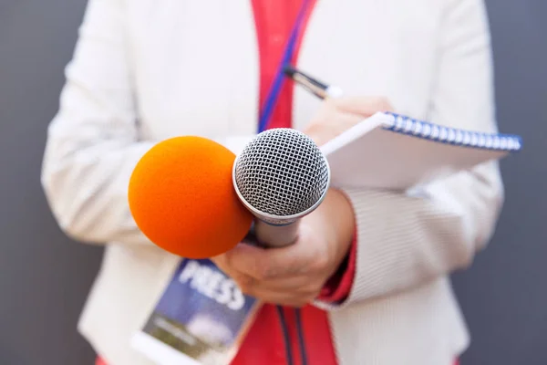 Female Journalist News Conference Writing Notes Holding Microphone — Stock Photo, Image