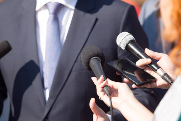 Journalists making media interview with business person or politician