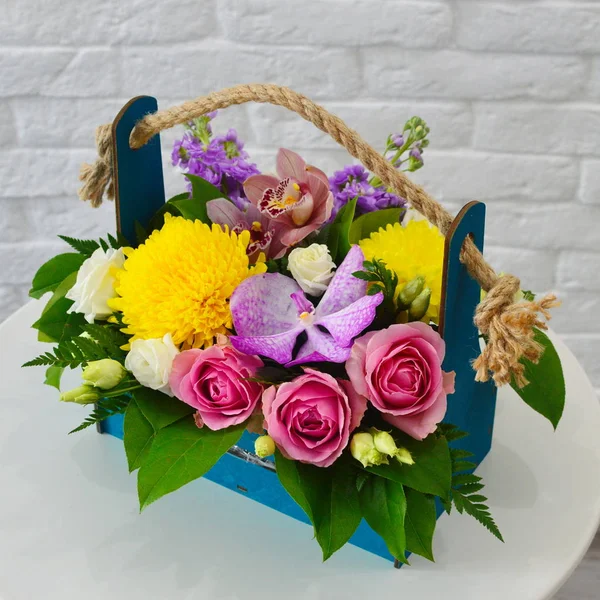 Beautiful flowers in stylish hat box. Concept of flower salon. Photo for flower website or catalog.