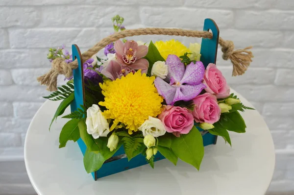 Flower composition in original hatbox. Beautiful flowers in stylish hat box. Concept of flower salon. Photo for flower website or catalog.