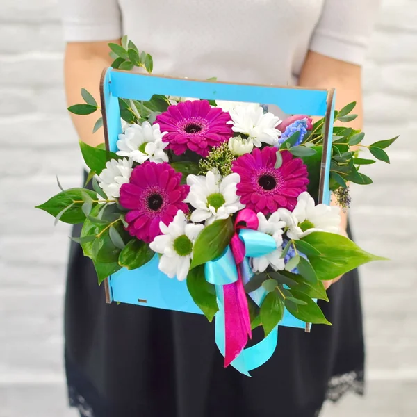 Flower composition in original wooden box. Beautiful flowers in stylish hat box. Concept of flower salon. Photo for flower website or catalog.