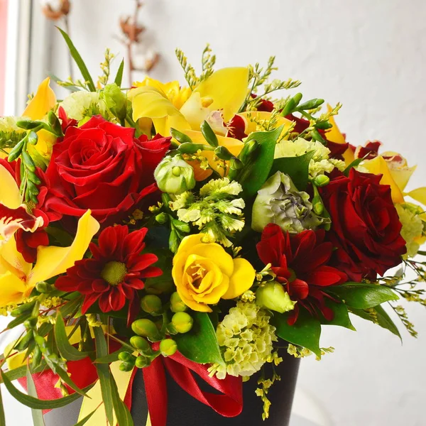 bouquet of red and yellow roses in the box