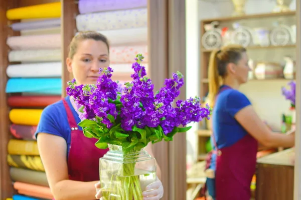 Beautiful lovely bouquet of spring mattiola flowers for flower shop. Concept of flower shop.  Bouquet for catalog. Florist woman at work. Beautiful pleasant work. Florist makes composition of flowers.Work of professional florist.