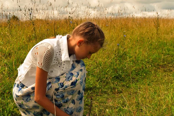 Beautiful girl with  fair hair in field on summer. Rural summer natural landscape. Typical Slavic appearance of girl teenager.