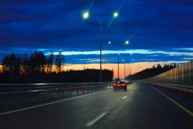 The car goes along the night highway.