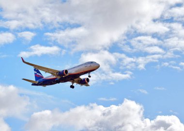 Bulutlarda mavi gökyüzünde bir uçak.