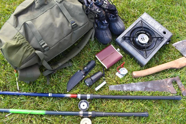 Cosas cazadoras en la hierba. Un conjunto necesario de artículos para el viaje extremo natural . — Foto de Stock