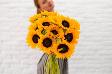İçinde büyük bir buket sarı ayçiçeği var.