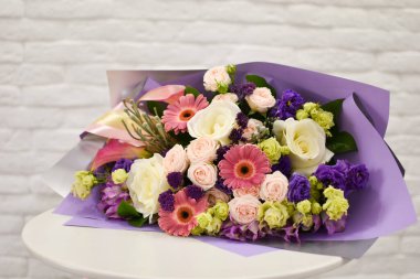 Mağazanın masasında duran güzel bir buket taze çiçek.