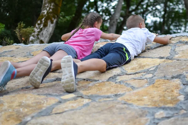 Мальчик и девочка играют на горе. дети туристы путешественники восхождение на гору. — стоковое фото