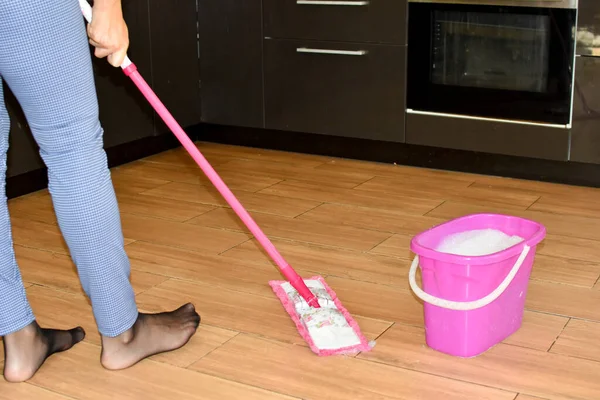 housewife washes floors at home. routine home cleaning work