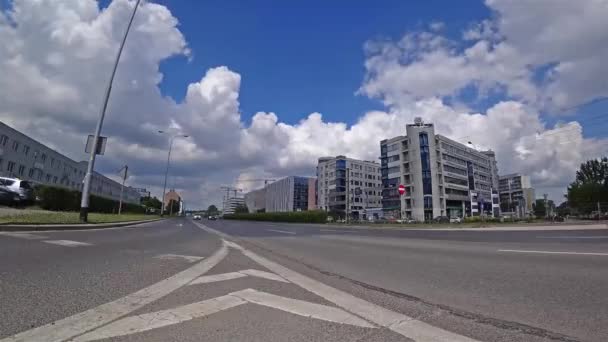 Many cars are driving on a city street at rush hour on a background of clouds in a blue sky Time-lapse 4K. — Stock Video