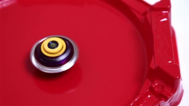 流行的现代儿童游戏贝叶刀爆裂快速旋转在红色的竞技场上 陀螺仪 纺纱机日本玩具 — 图库视频影像