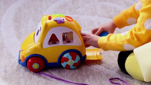 Little Girl Plays Yellow Educational Toy Car Sitting Floor Kindergarten — Stock Video